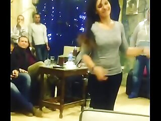 arab woman dancing with friends in cafe